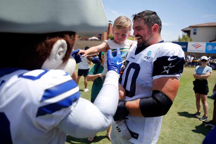 Dallas Cowboys guard Zack Martin introduces his son Charlie to the mascot, Rowdy, following...