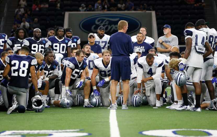 Dallas Cowboys head coach Jason Garrett talks to the team after practice during training...