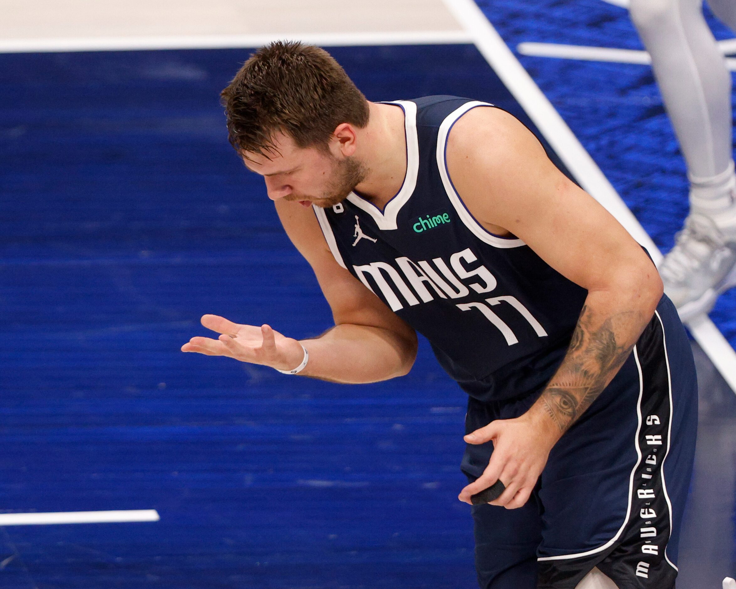 Dallas Mavericks guard Luka Doncic (77) looks at his hand during the first half of the home...