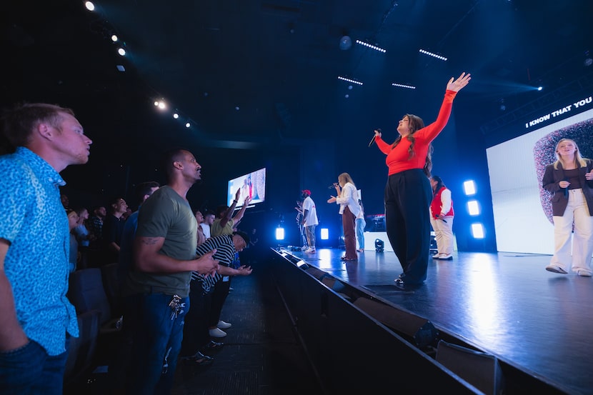 Anna Golden, center, leads worship at Shoreline City Church on Aug. 6.