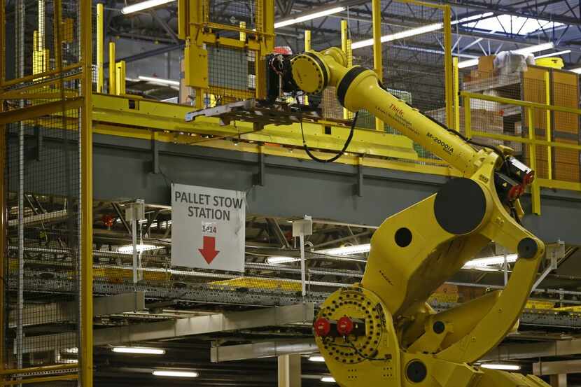 The Robo-Stow moves pallets from level to level at the Amazon.com fulfillment center in...