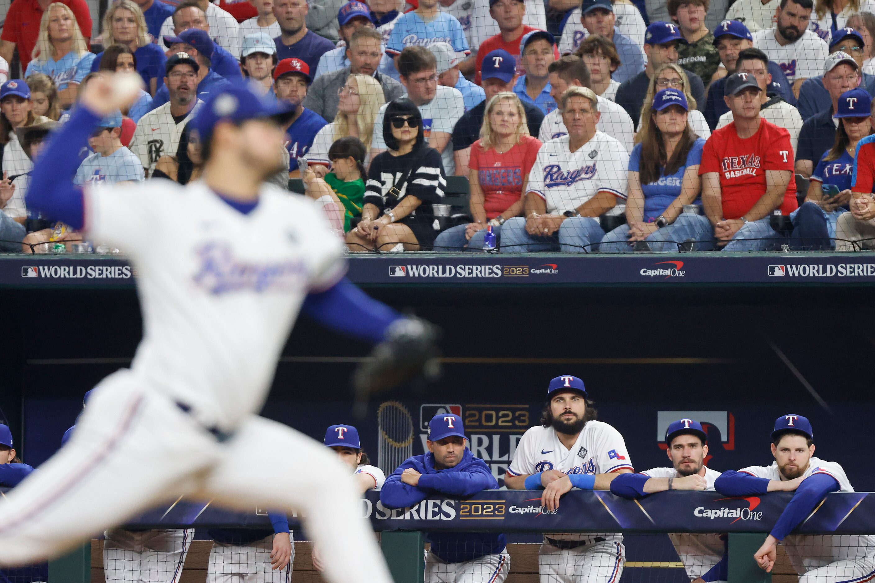 The Texas Rangers bench watches as relief pitcher Dane Dunning delivers during the seventh...