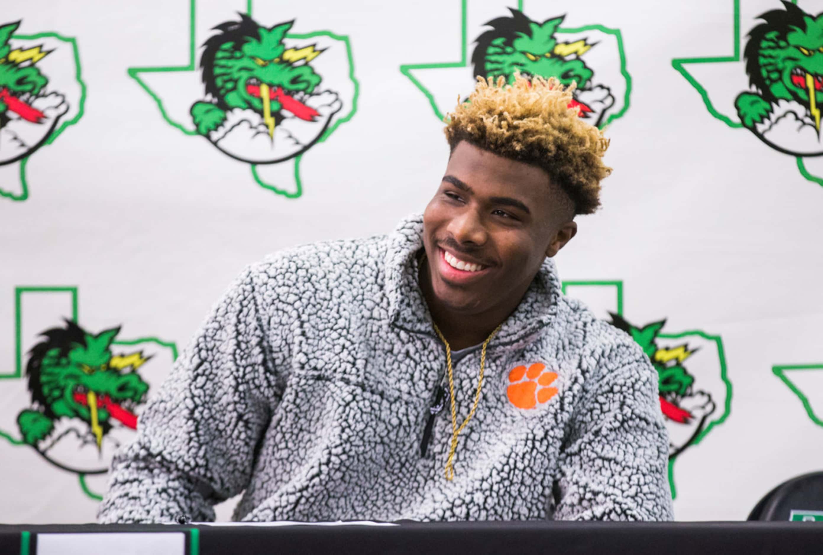Southlake Carroll football player RJ Mickens reacts after signing a national letter of...