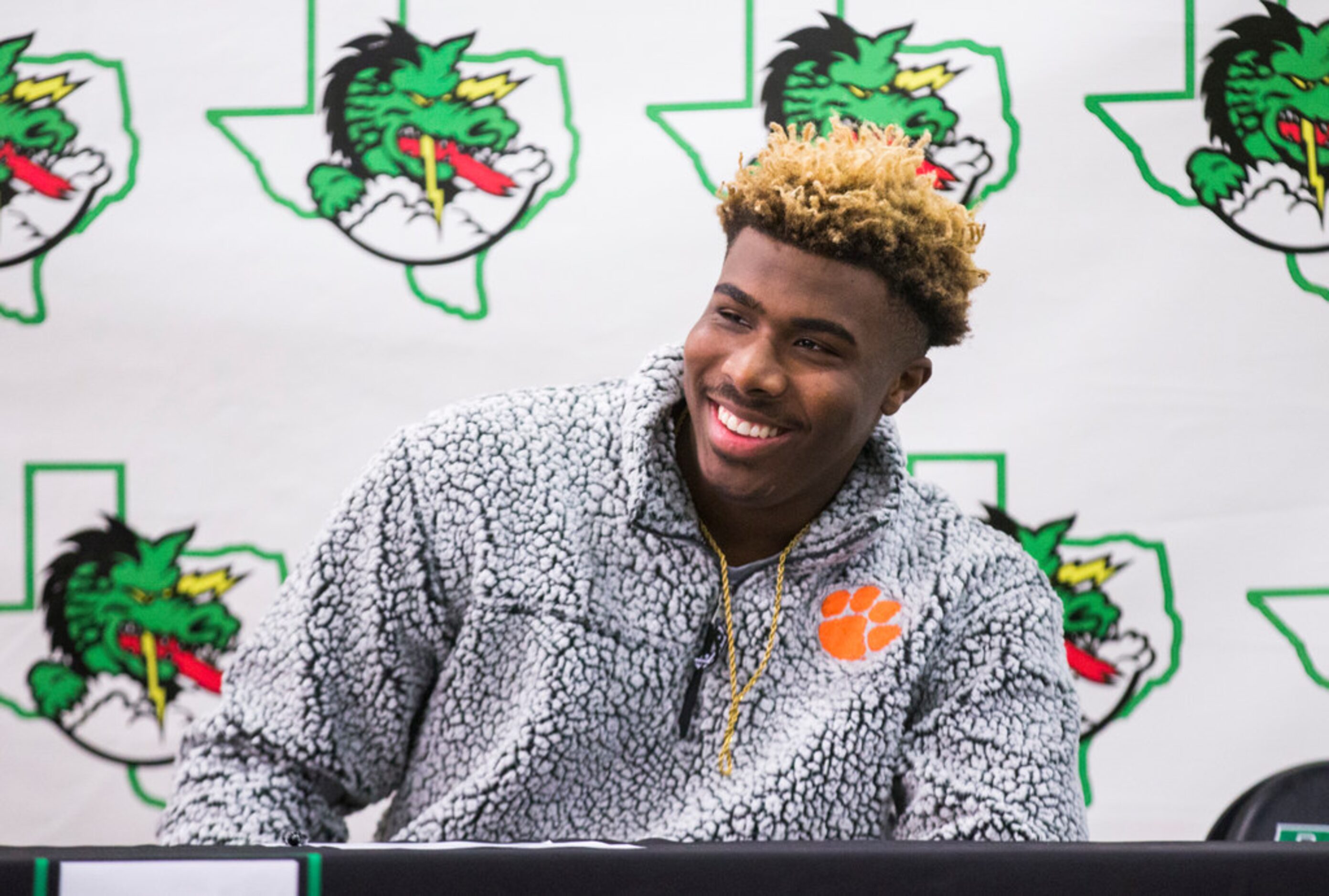 Southlake Carroll football player RJ Mickens reacts after signing a national letter of...