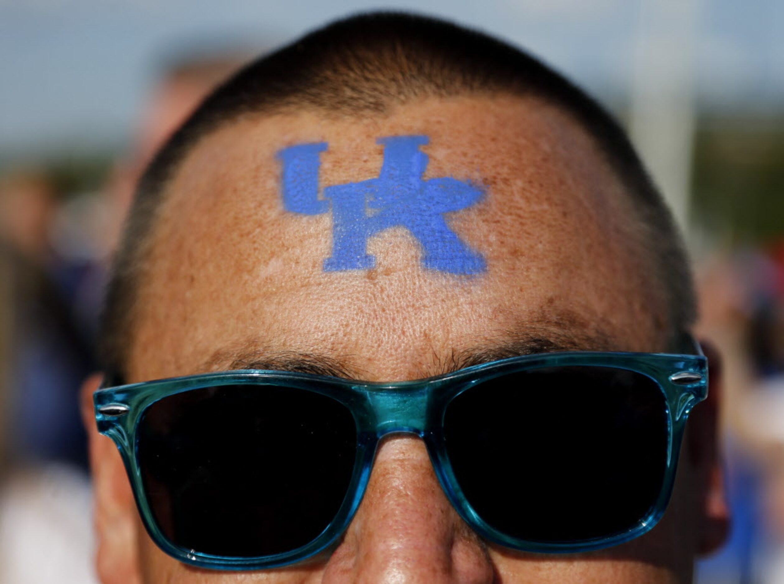 Bryan Robinson of Abilene, Texas shows his Kentucky Wildcats pride on his forehead at the...