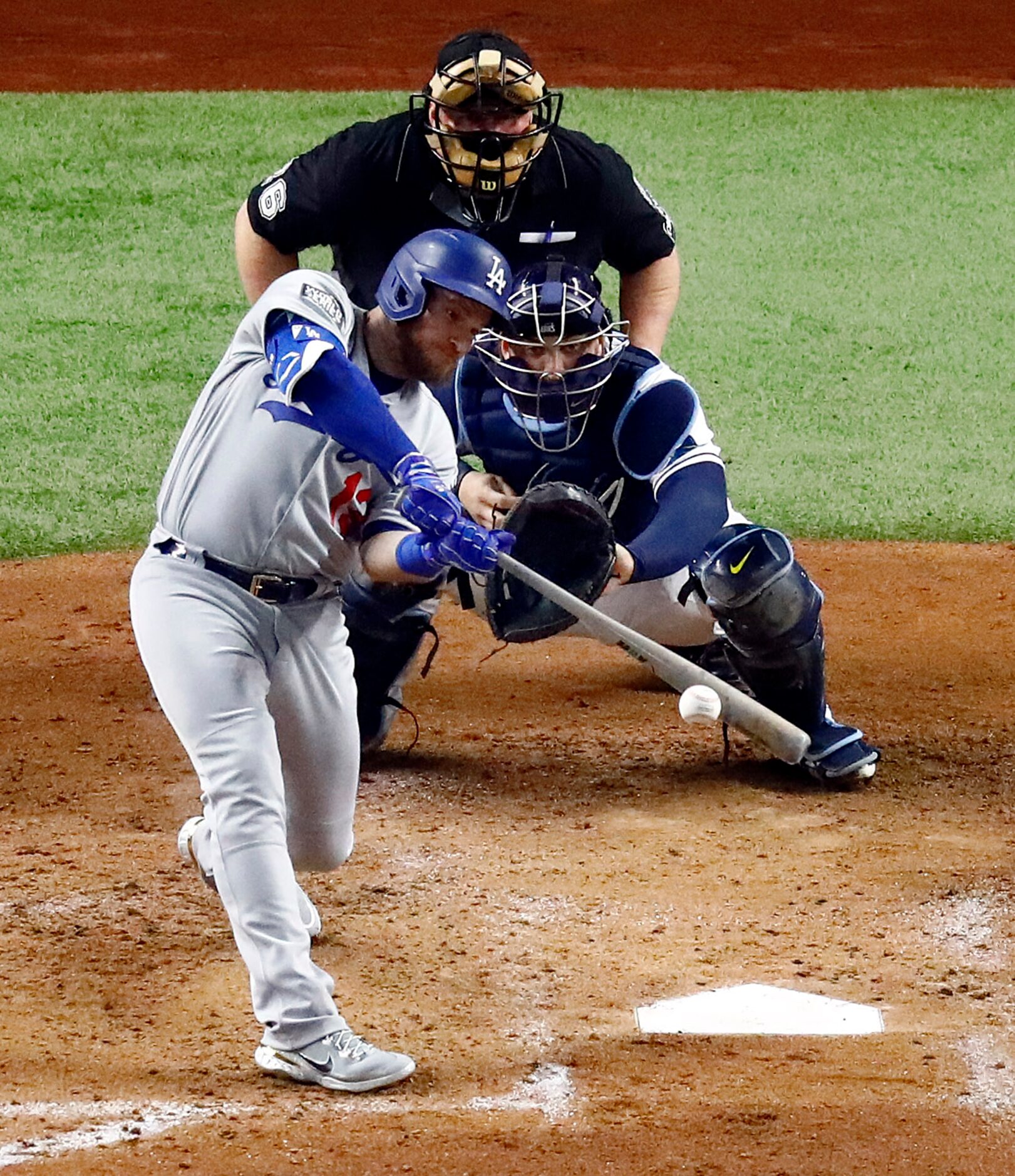 Los Angeles Dodgers Max Muncy (13) connects on a two-run single against the Tampa Bay Rays...