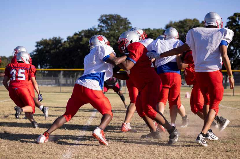 Spruce High School football players practice on Wednesday, Sept. 22, 2021, at H. Grady...
