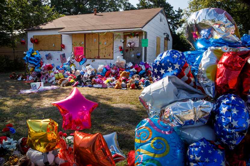A growing tribute to Shavon Randle fills the yard of the abandoned house in the 2200 block...