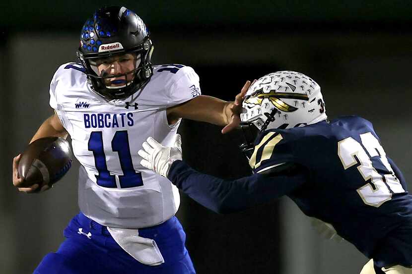 Byron Nelson quarterback Jacob Wilson (11) gives a stiff arm to Keller linebacker Treyce...