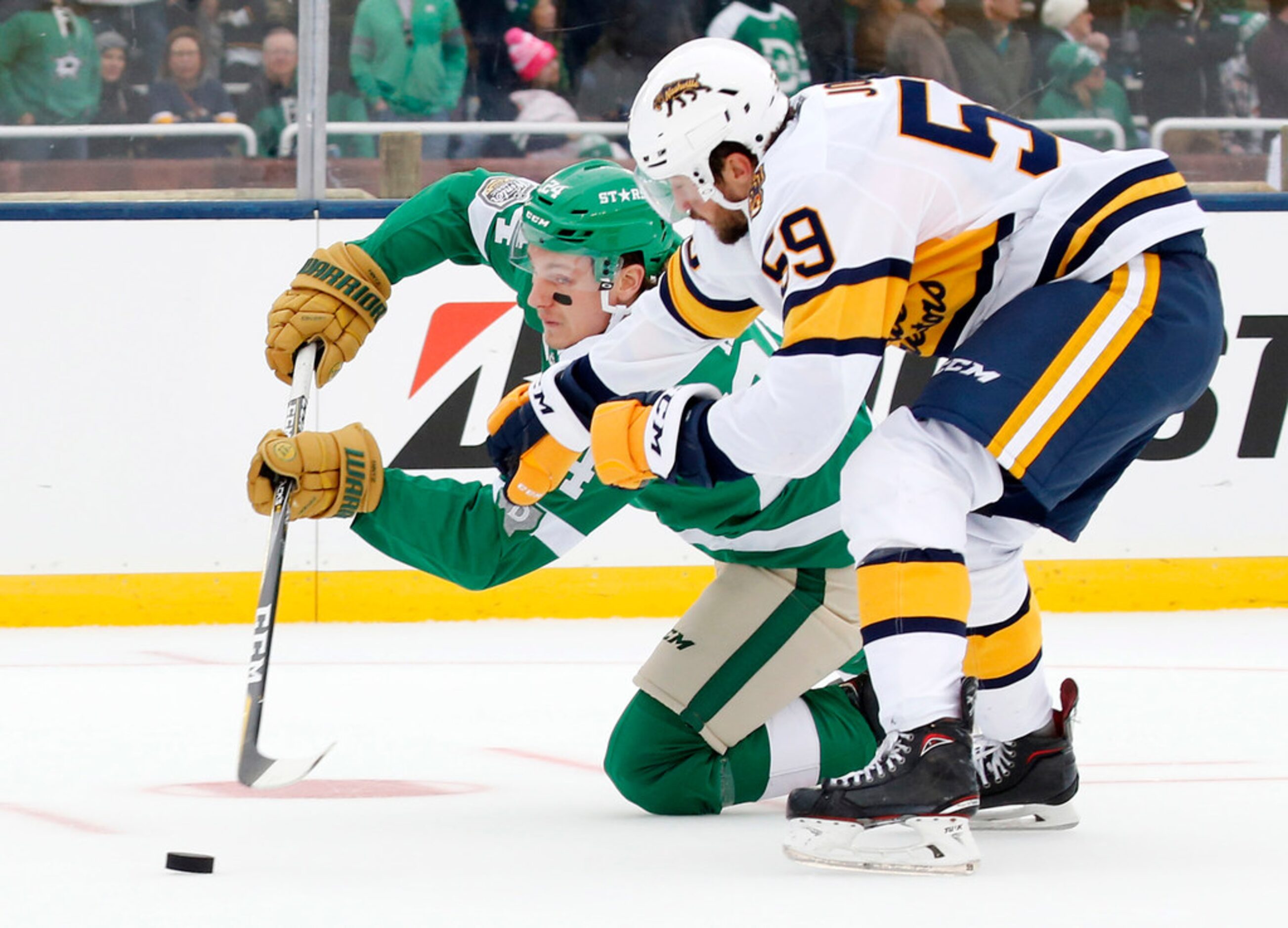 Dallas Stars left wing Roope Hintz (24) passes the puck as he's taken down by Nashville...