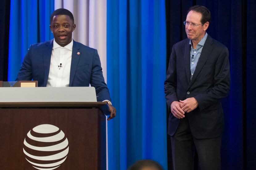AT&T employee James Shaw Jr., left, joined by AT&T CEO Randall Stephenson, and AT&T...