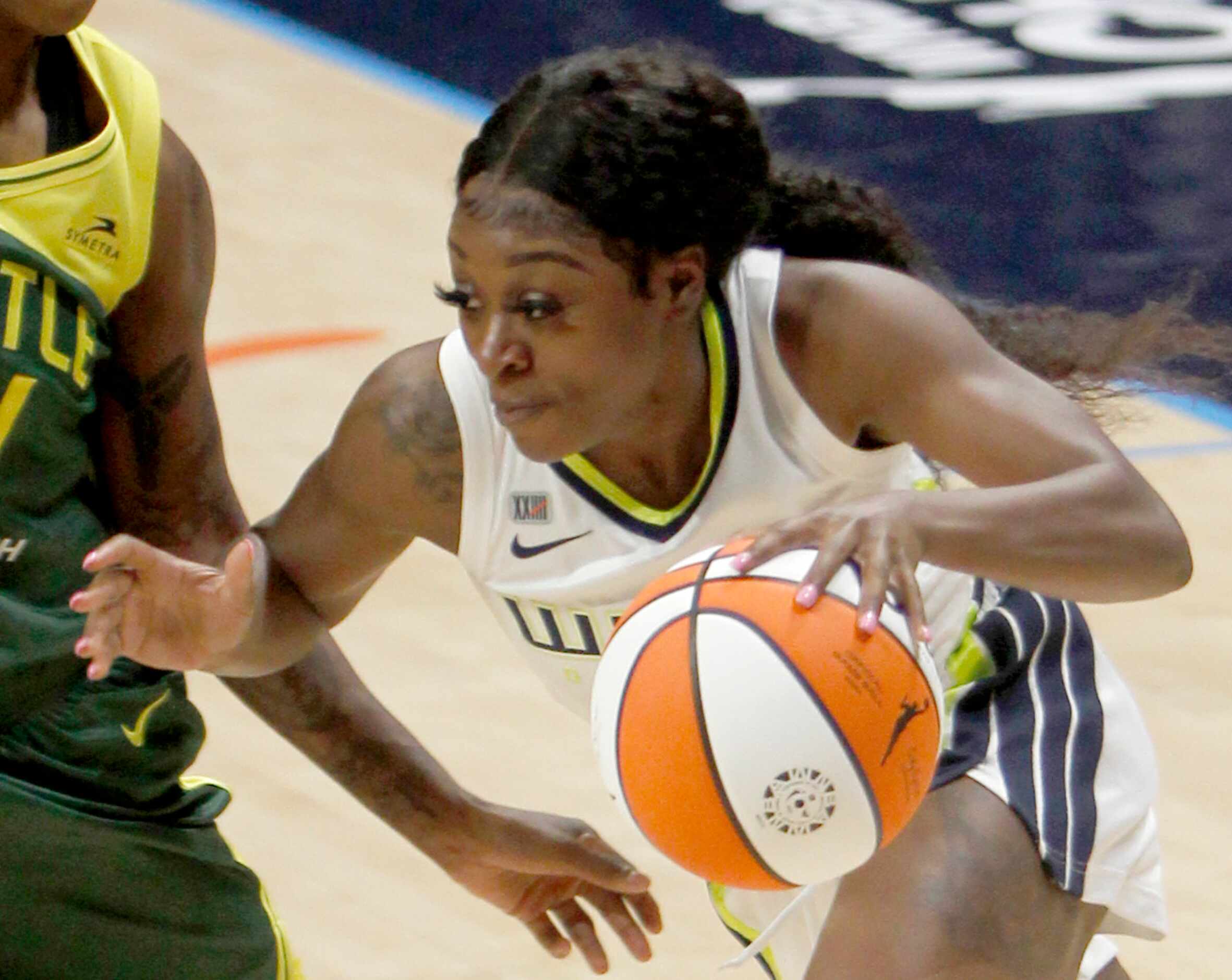 Dallas Wings guard Dana Evans (13) drives against a Seattle defender during first half...