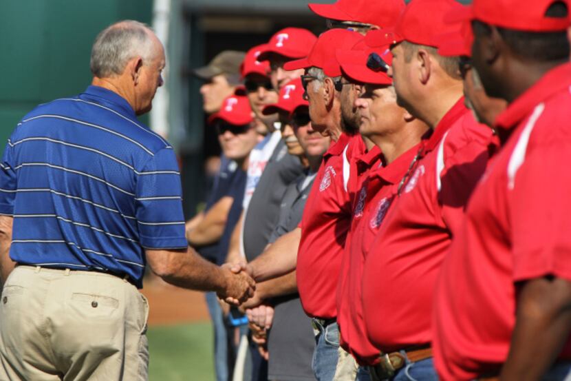 Texas Rangers CEO Nolan Ryan shook hands with West first-responders during the pre-game...