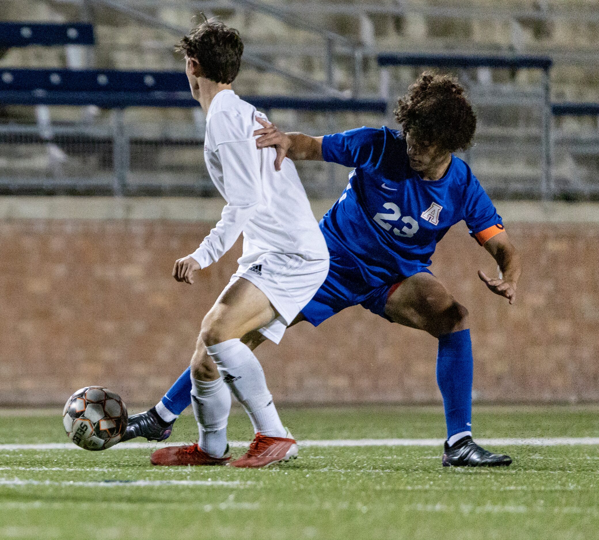 Allen High School Ayden Mendoza kicks the ball away from  Lake Highlands High School Jake...