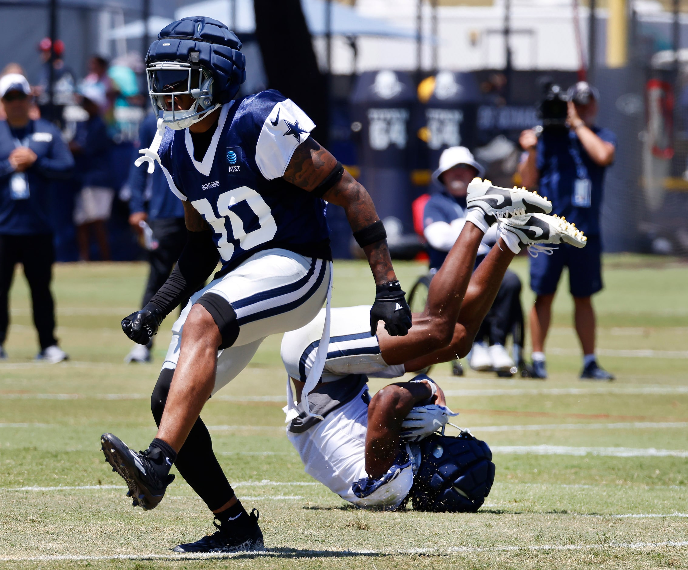 Dallas Cowboys wide receiver Brandin Cooks (3) rolls upside down after making a sliding...