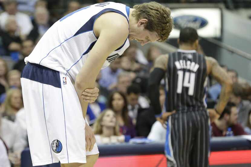 Dallas Mavericks power forward Dirk Nowitzki  of Germany holds his arm after a hard foul...