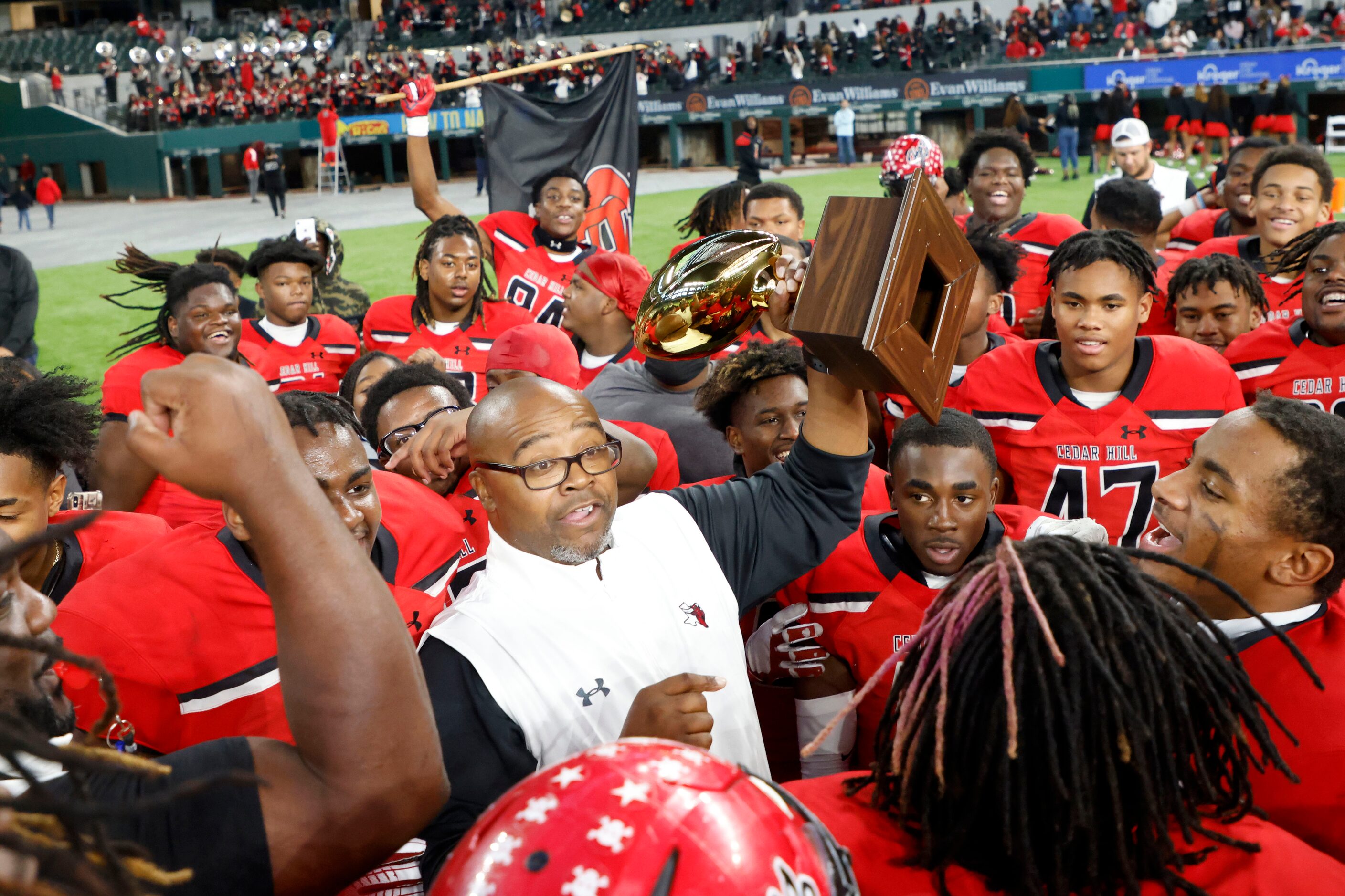 Cedar Hill coach Carlos Lynn celebrates with the team after they defeated Tyler Legacy 21-7...