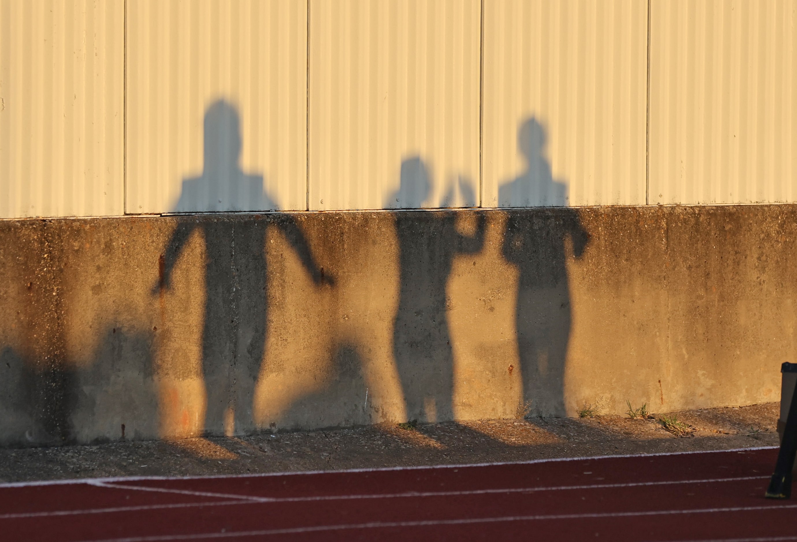 The shadows of student band members direct the band before the start of the first half of a...