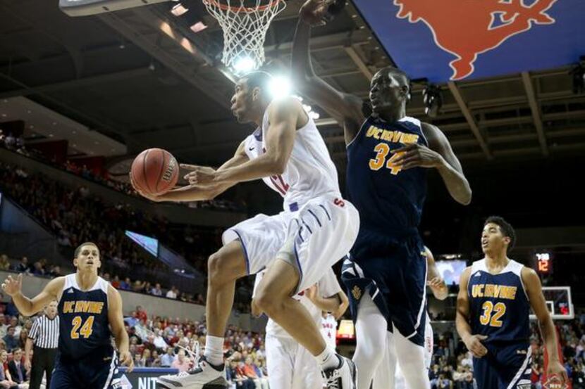 
SMU Mustangs guard Nick Russell (12) drives around UC Irvine Anteaters center Mamadou...