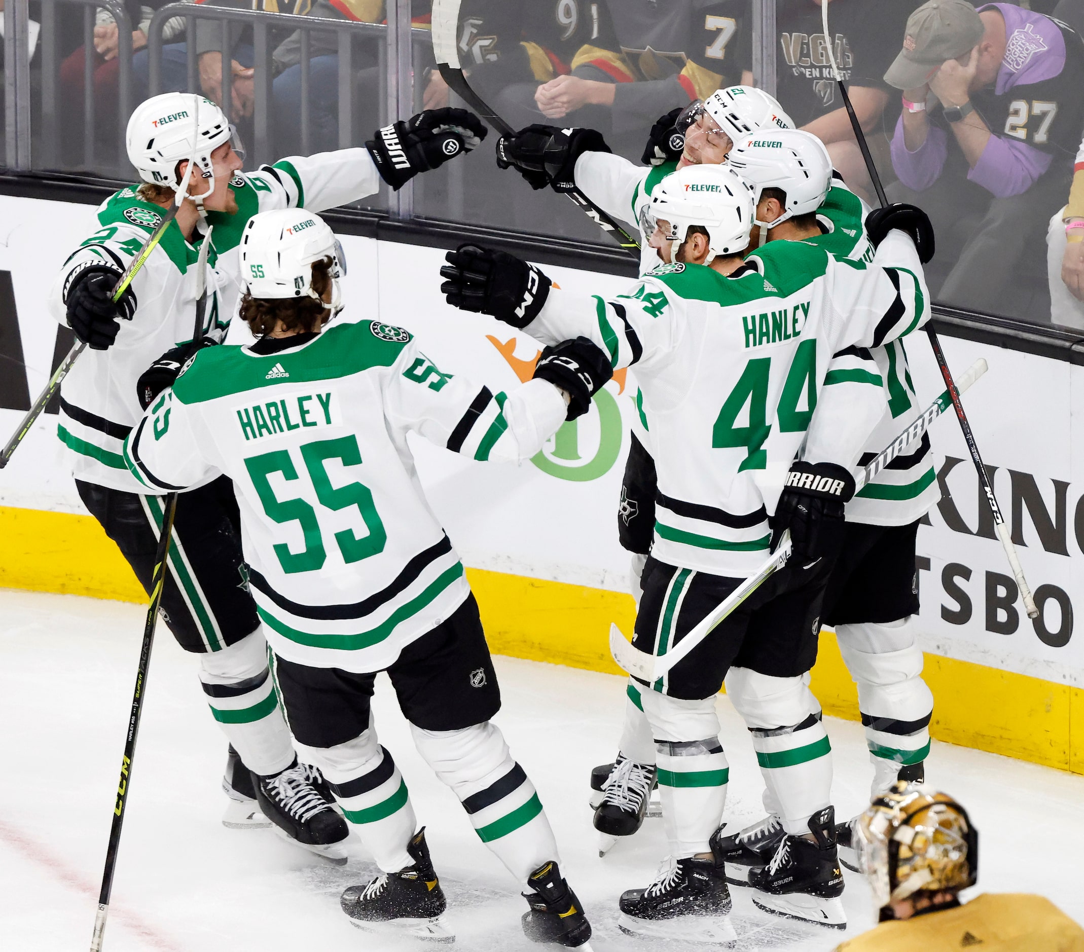 Dallas Stars left wing Jason Robertson (21) is congratulated by teammates following his...