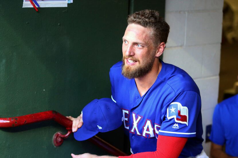 Texas Rangers designated hitter Hunter Pence (24) stands in the dugout before a baseball...