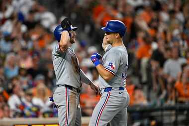Texas Rangers' Nathaniel Lowe, right, celebrates after his two-run home run off Baltimore...