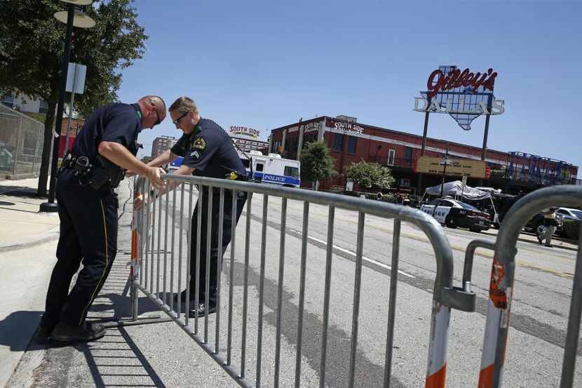 Dallas police officers set up barricades hours before the Donald Trump campaign rally at...