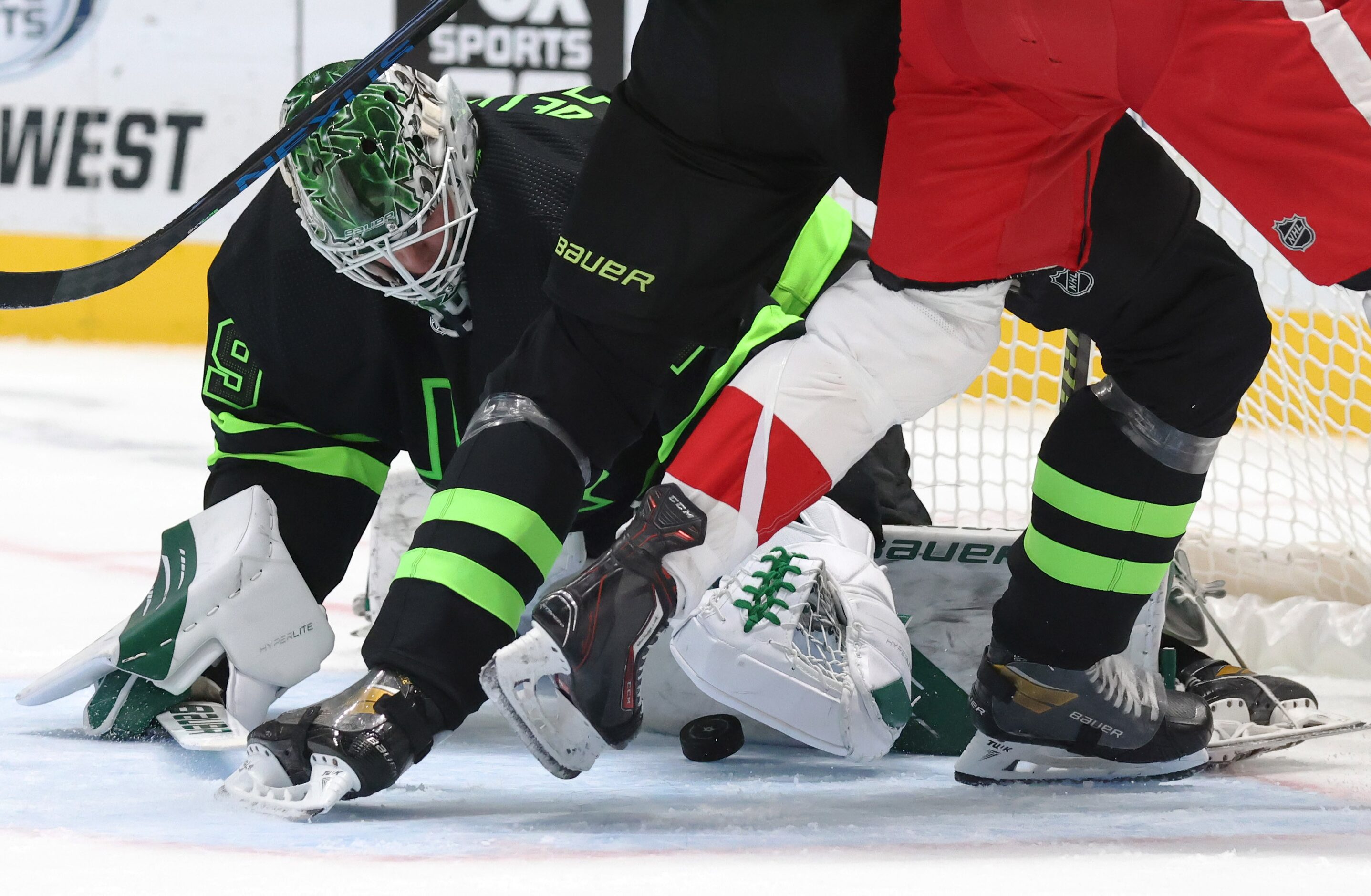 Dallas Stars goaltender Jake Oettinger (29) stops a shot on goal as Dallas Stars defenseman...