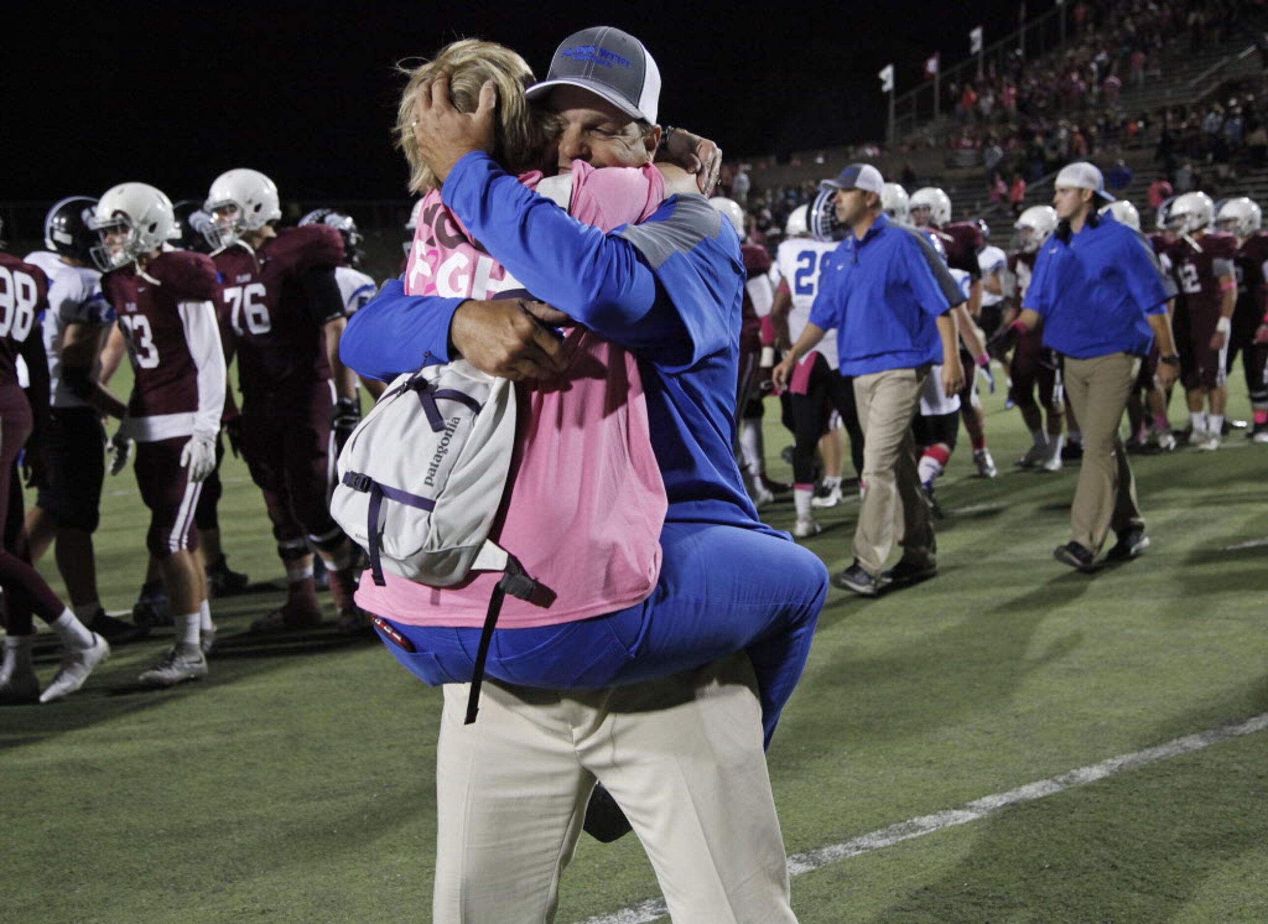 Plano West Head Coach Scott Smith is embraced by his wife Chrissy after Plano West made a...