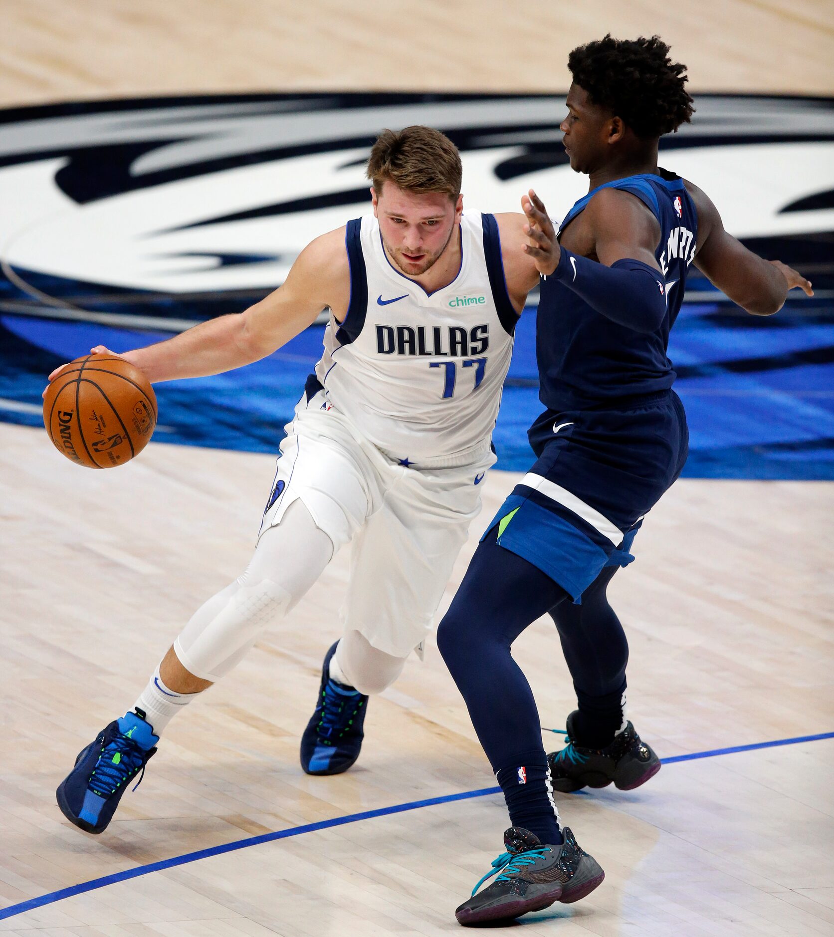 Dallas Mavericks guard Luka Doncic (77) drives on Minnesota Timberwolves Anthony Edwards...