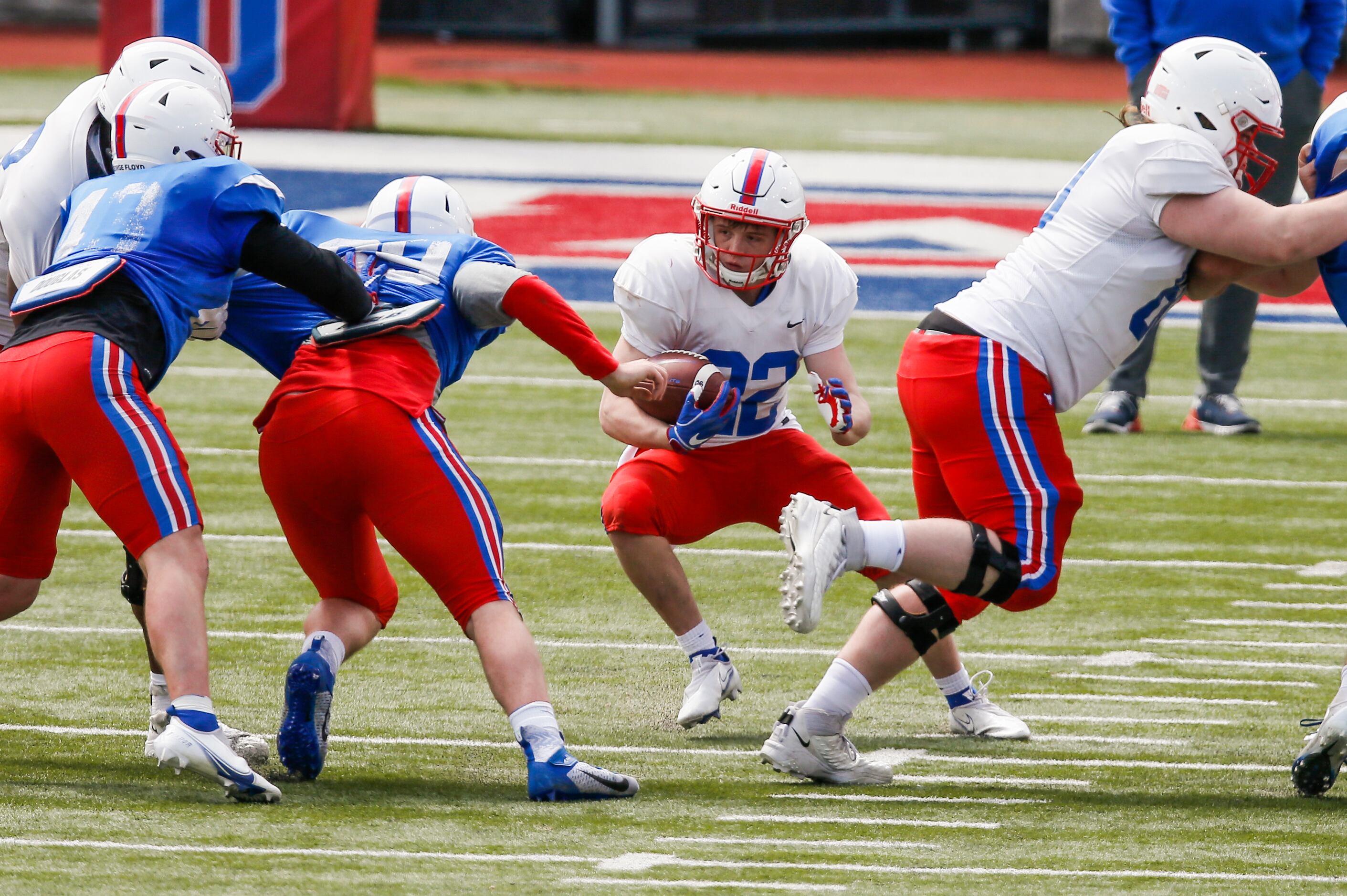 SMU running back Blake Bedwell (22) looks for room against the SMU defense during practice...