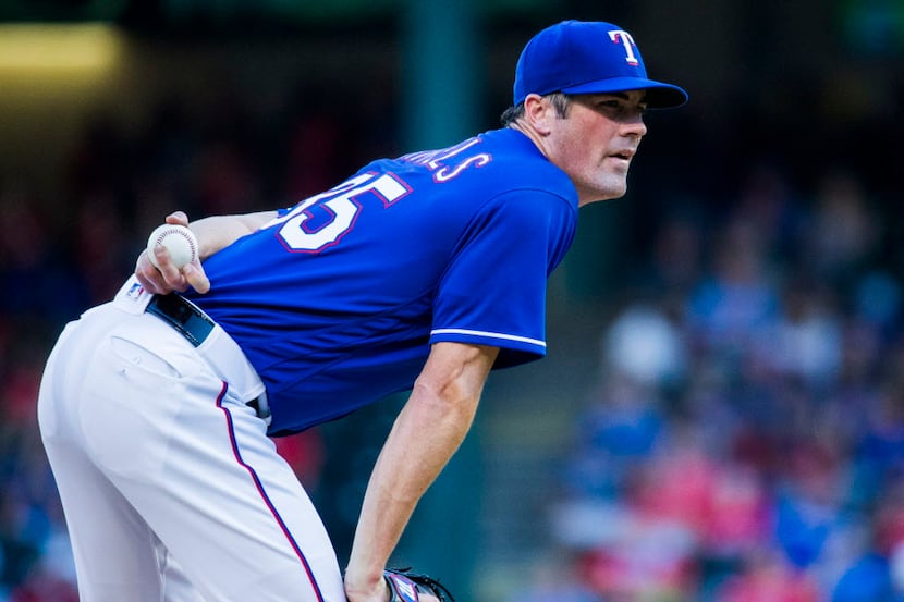 Texas Rangers starting pitcher Cole Hamels (35) looks for a signal on the mound during the...