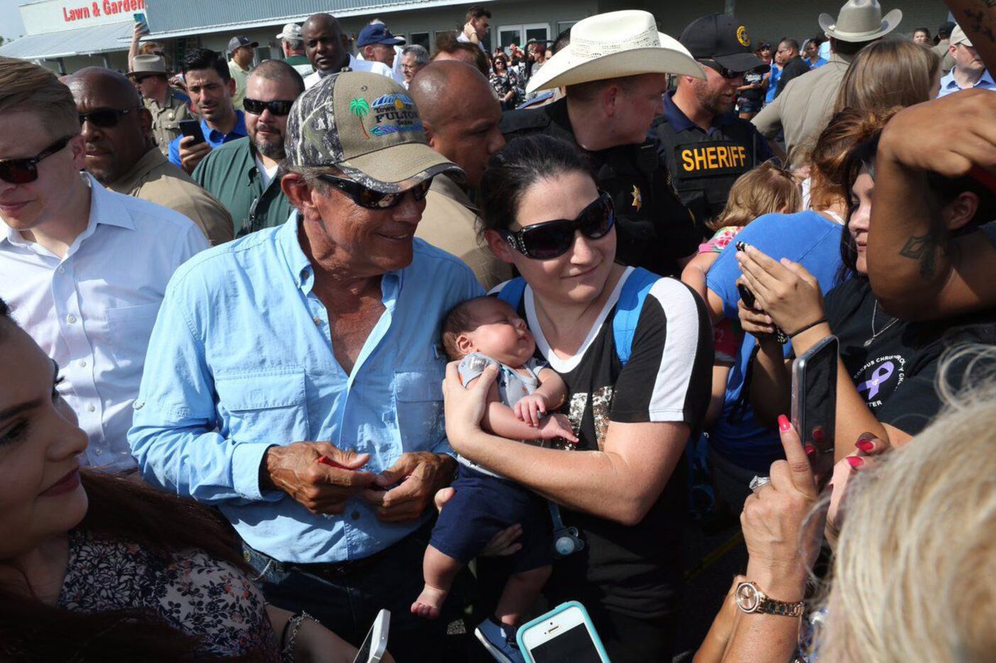 Country singer George Strait (left) signs autographs for fans while visiting Rockport on...