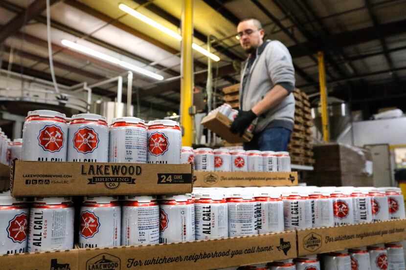 Jeremy Lee, packaging tech, stacks cans of All Call, one of the core beer brands at Lakewood...