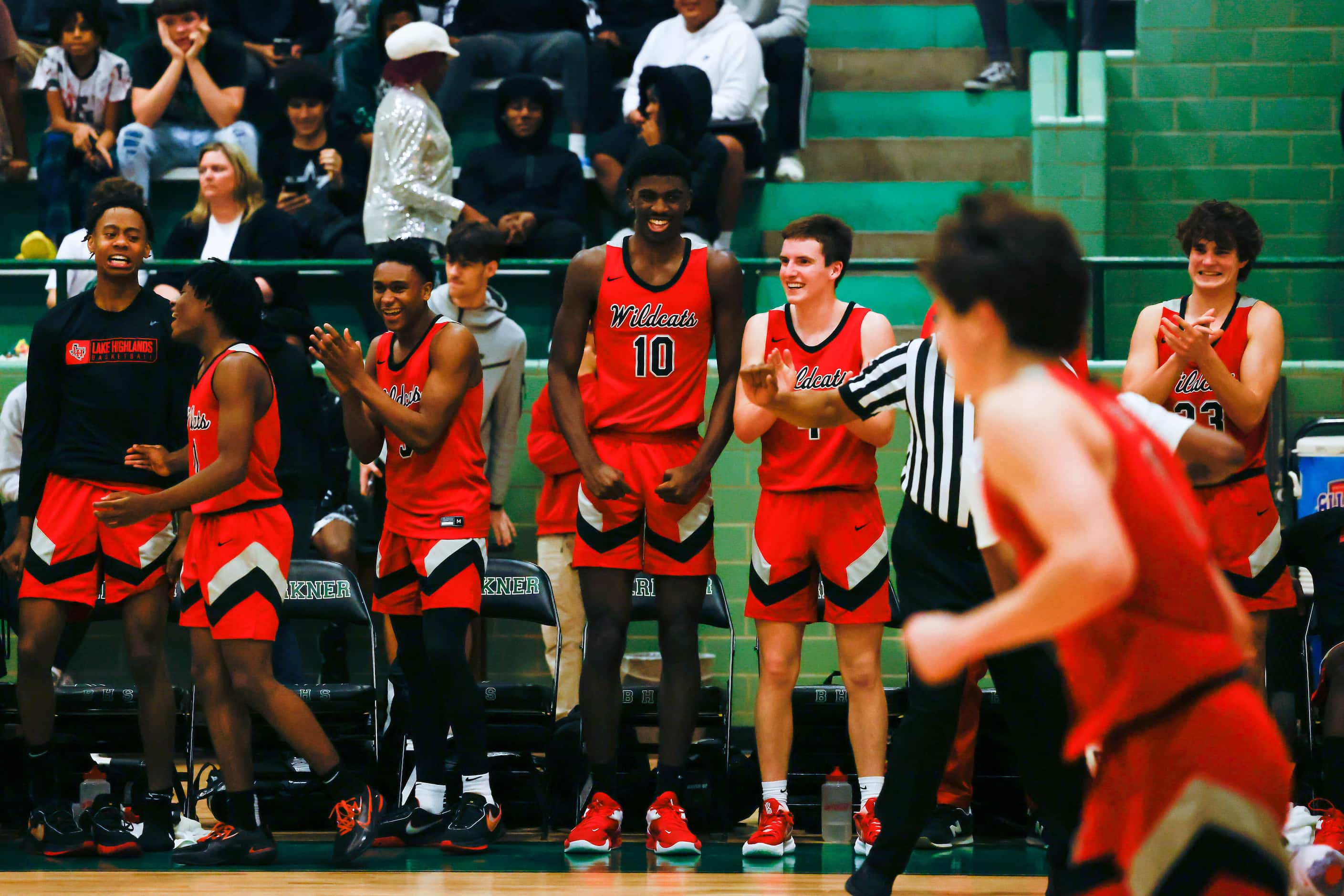 Lake Highlands High School team celebrates a dunk by Jaire Williams #12 during the second...