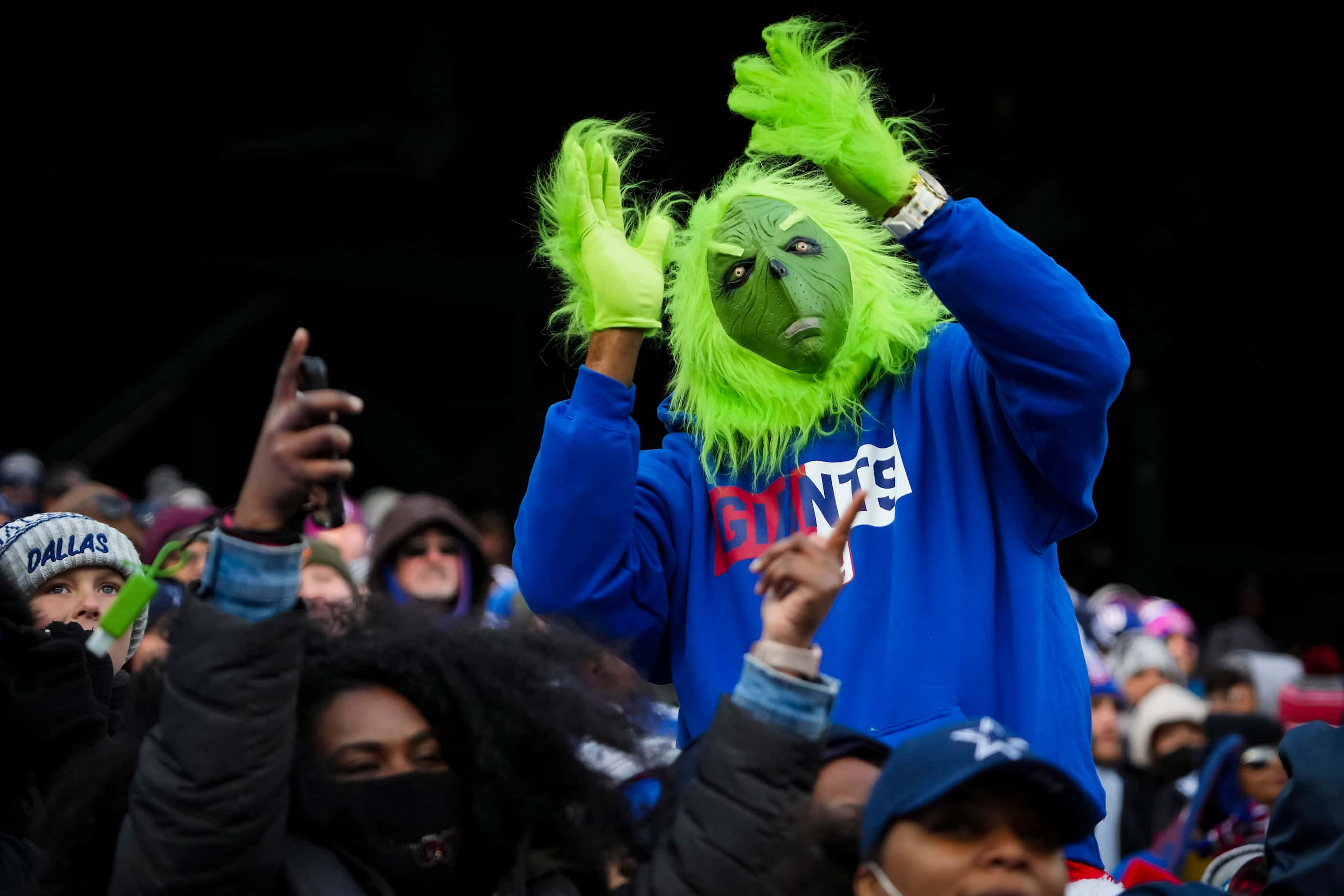 A New York Giants fans wearing a Grinch costue cheers during the first half of an NFL...