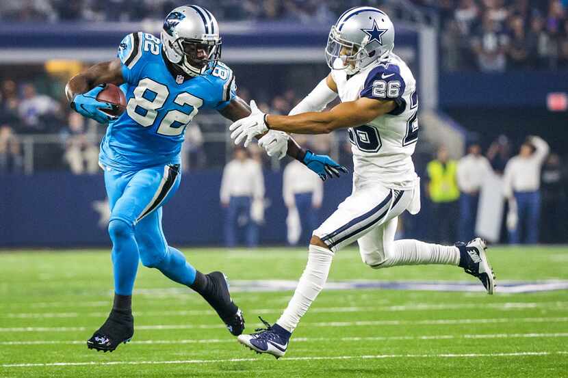 Carolina Panthers wide receiver Jerricho Cotchery (82) tries to fight his way around Dallas...