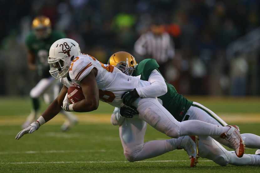 WACO, TX - DECEMBER 07: Malcolm Brown #28 of the Texas Longhorns is tackled by Cole Edmiston...