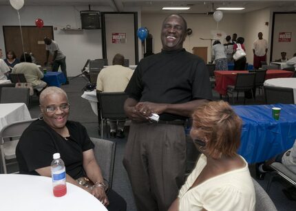 Dennis Webb talks with Lillian Sidney, left, and Kimberly Shields as he makes his way around...