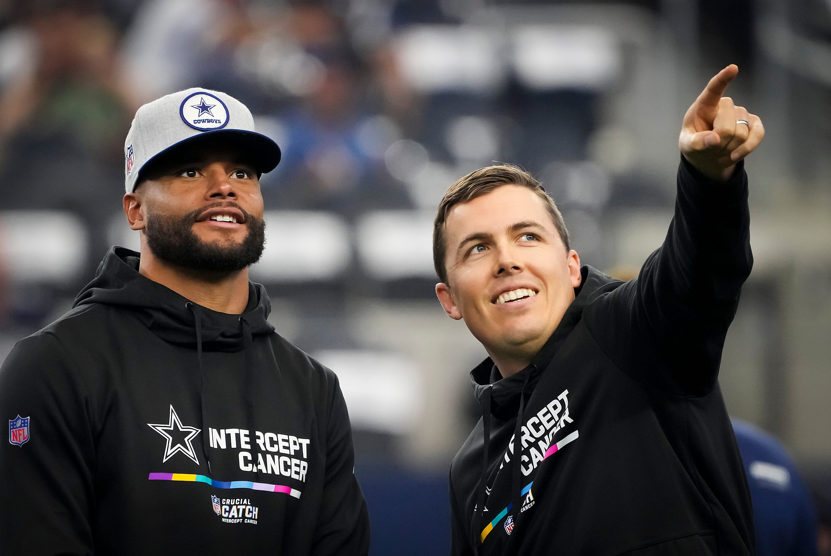 Dallas Cowboys quarterback Dak Prescott talks with offensive coordinator Kellen Moore as the...