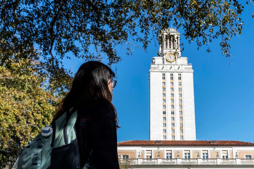 University of Texas at Austin student, Lupe, poses for a portrait under the Texas Tower as...