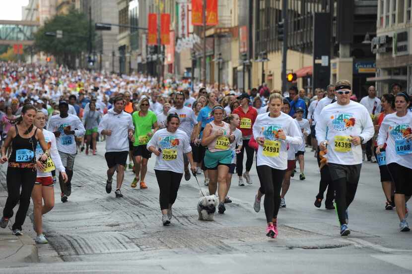 Runners hike the 5k down Main Street at the 45th annual Thanksgiving Turkey Trot at City...