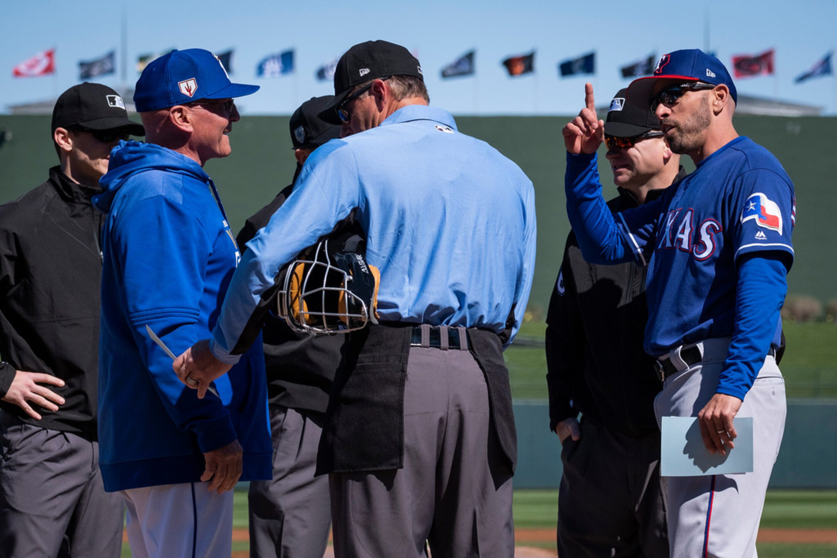 Texas Rangers manager Chris Woodward (right) and Kansas City Royals manager Ned Yost head...