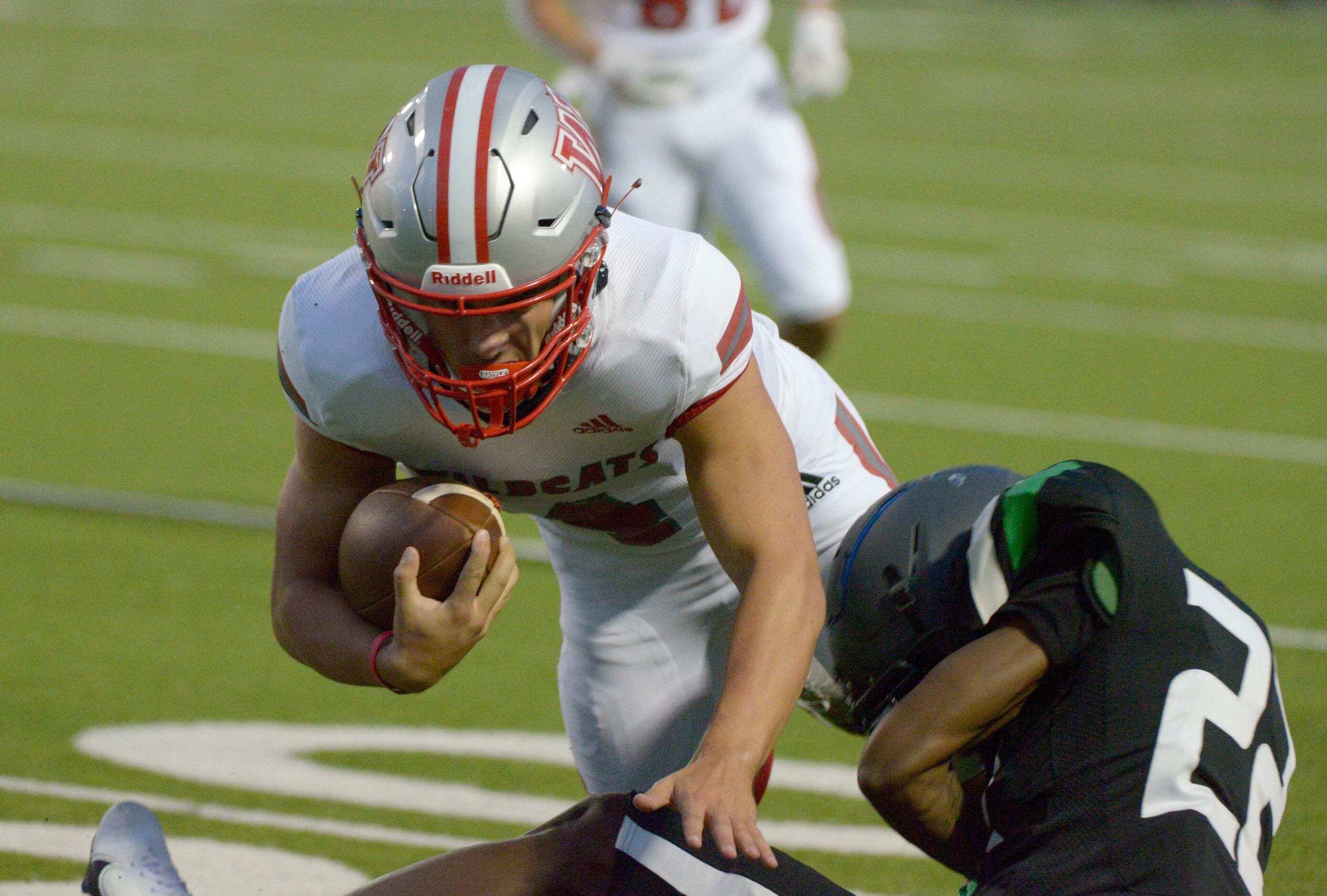 Woodrow Wilson’s Houston Robinson fights for yardage as he’s tackled by Berkner’s J’Braun...