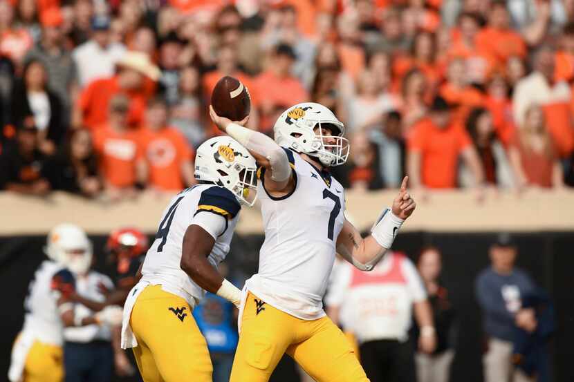 West Virginia quarterback Will Grier throws a pass during an NCAA college football game in...