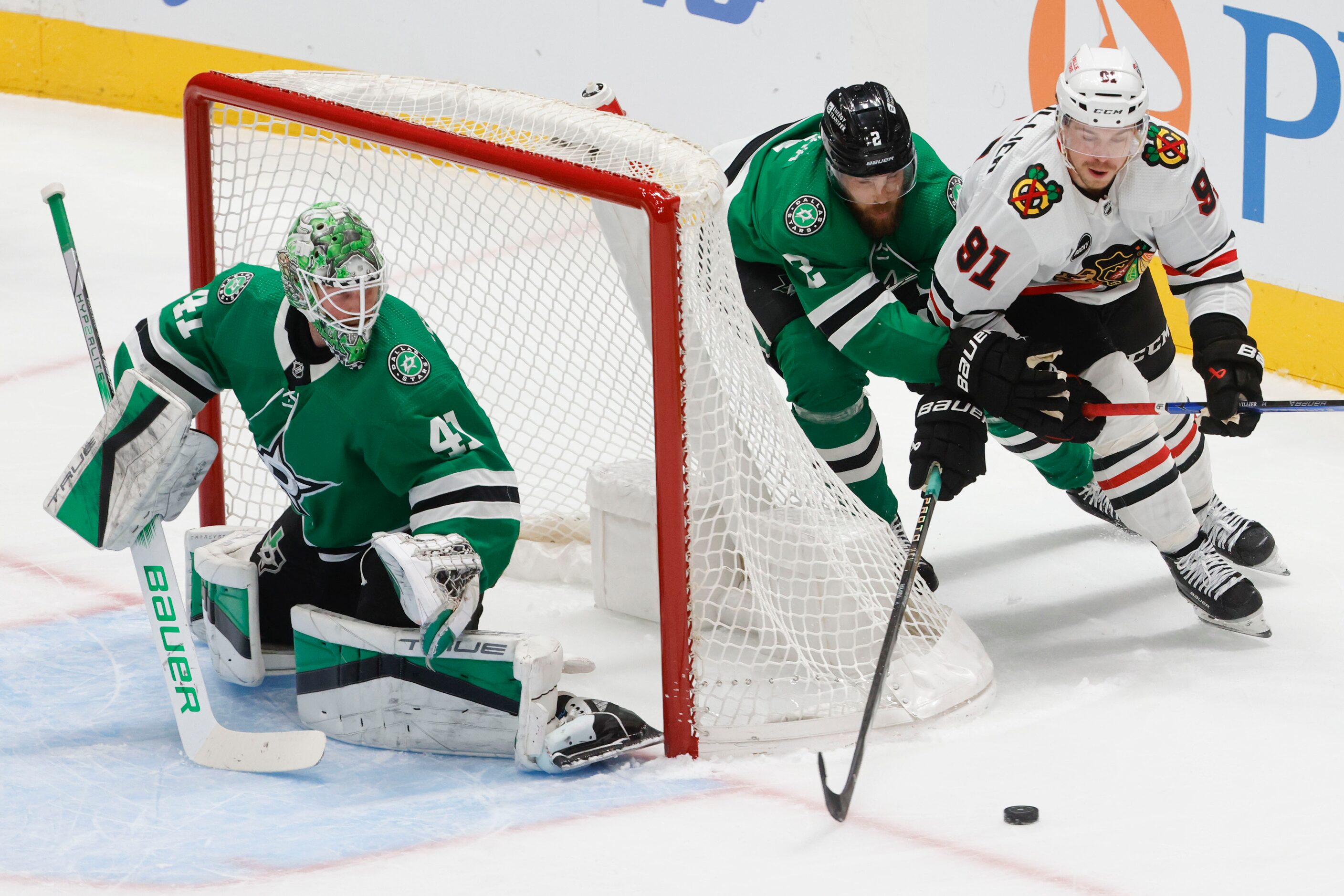 Dallas Stars goaltender Scott Wedge-wood (41) watches as defenseman Jani Hakanpaa (center)...