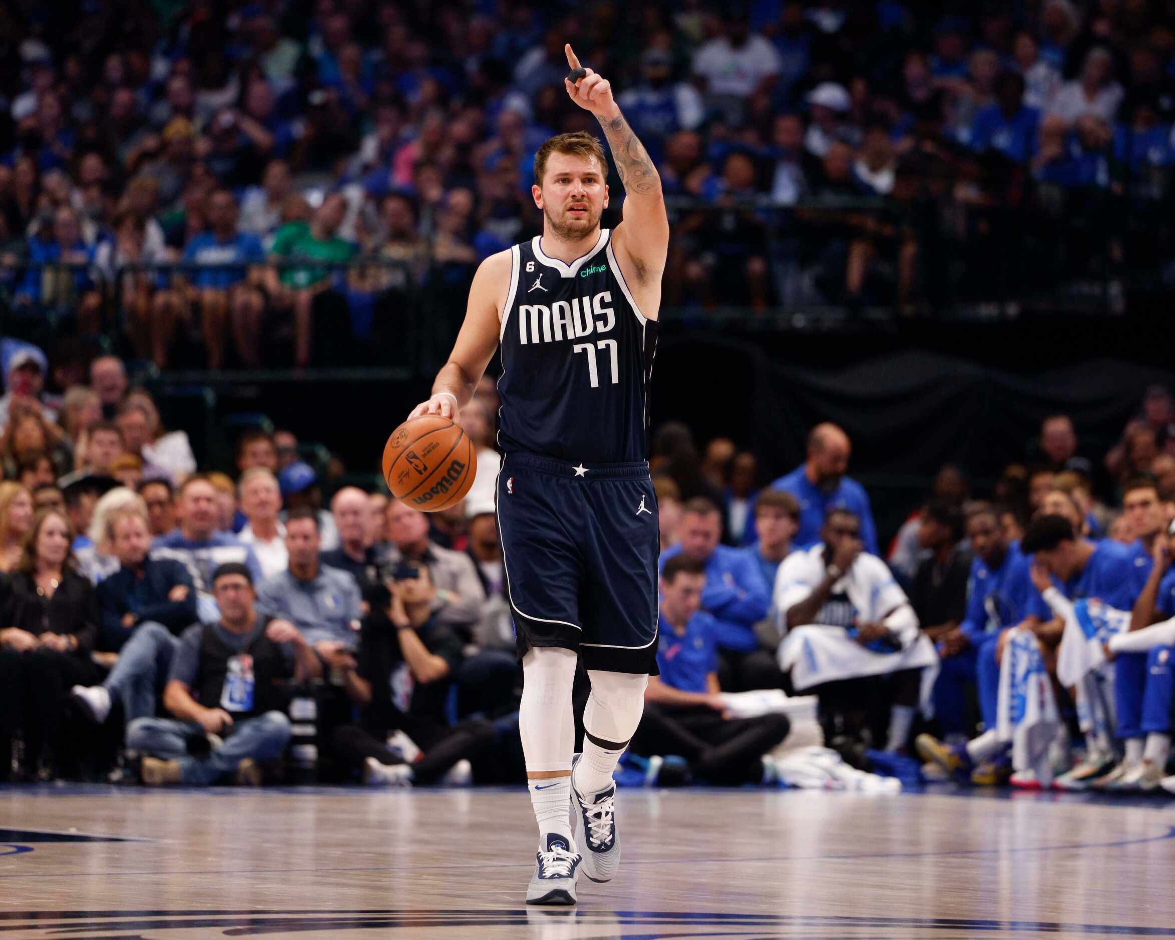 Dallas Mavericks guard Luka Doncic (77) signals to a teammate during the first half of the...