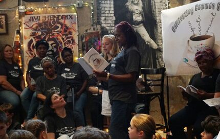 Ella Nichols (10 years old) and Ernestine Slampa, center, read a poem during the "Common...