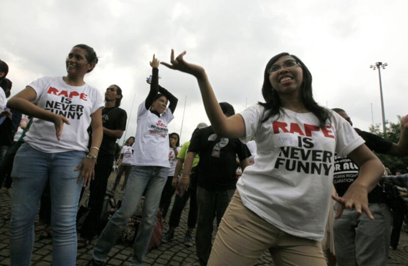 Indonesian women dance as they take part in the " One Billion Rising " campaign, a worldwide...