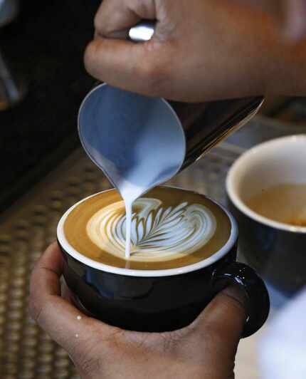 Barista Briana Flores prepares a cappuccino at Ascension Coffee Roasters in Dallas.
